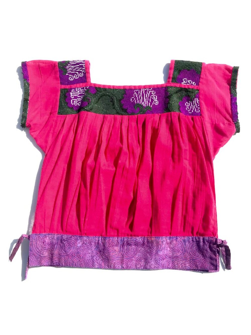 Unique cotton top from Mexico. Pleated with woven fabric and tied hem details.